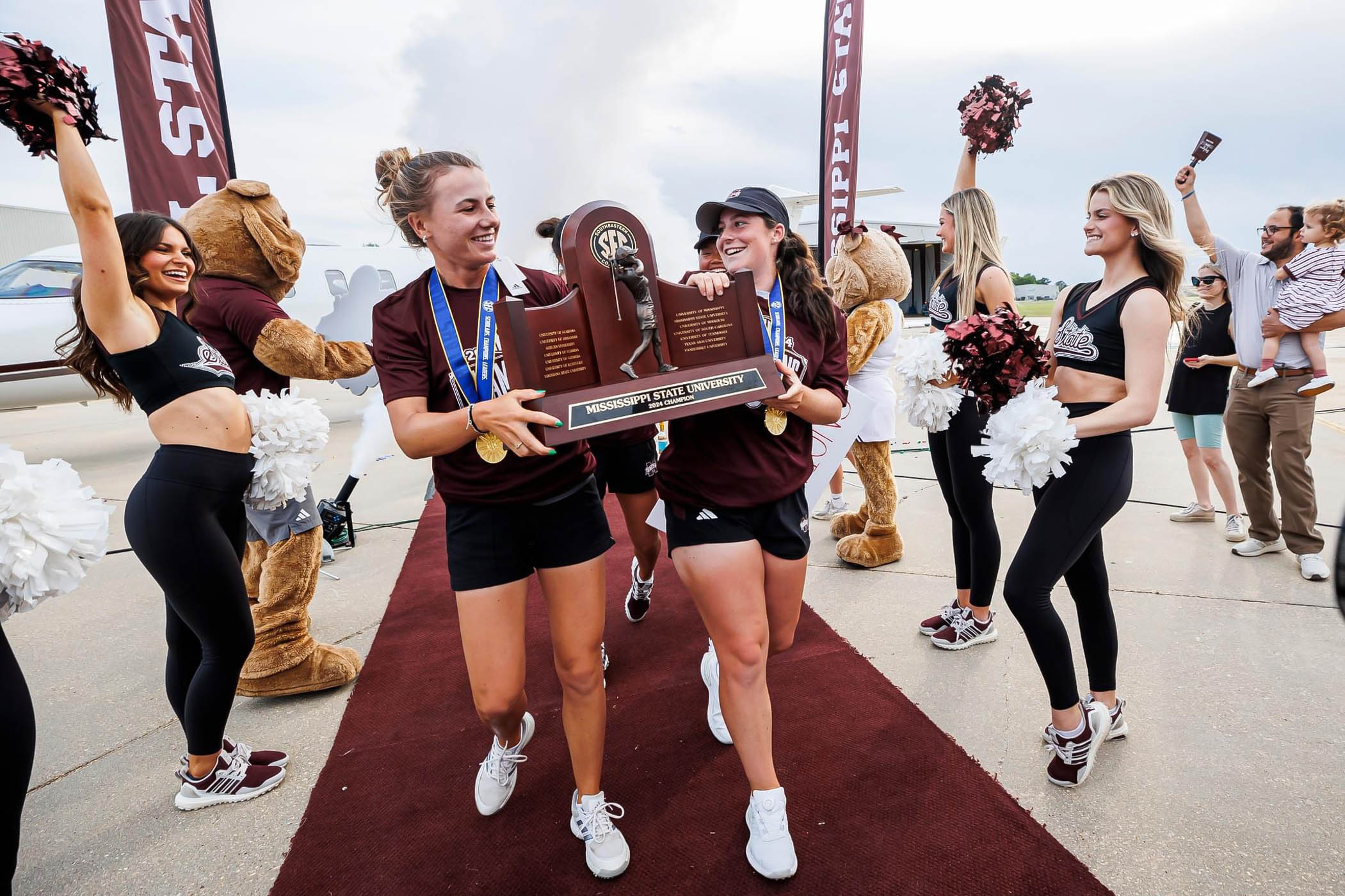 Chiara Horder, (Left,) Avery Weed, (R,) and the rest of Mississippi APP&#039;s Women&#039;s Golf team step off walk the maroon carpet as SEC champions for the first time in program history. 